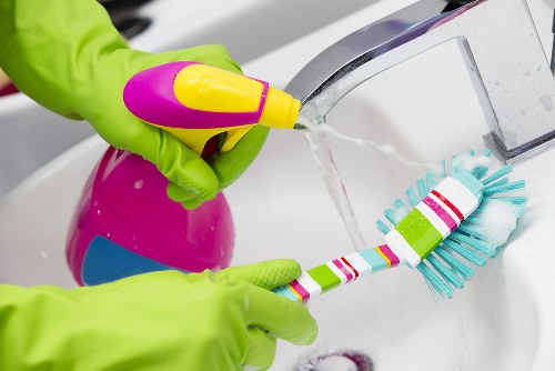 Professional carpet cleaner following safe working procedures