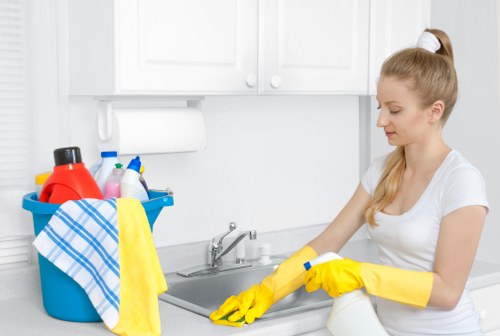 Professional cleaner wiping down a living space in a W1W home